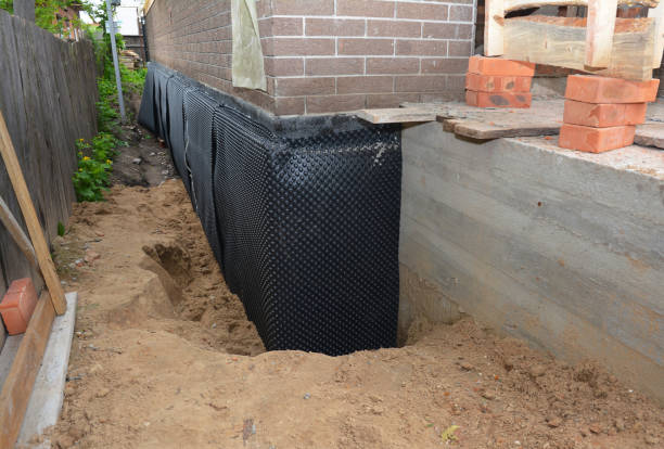 SJ Waterproofing Pros technician performing targeted Wet Basement Repair assessment in Ogdensburg, WI